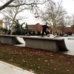Here's a picture of some skateboarders in the park during a winter day