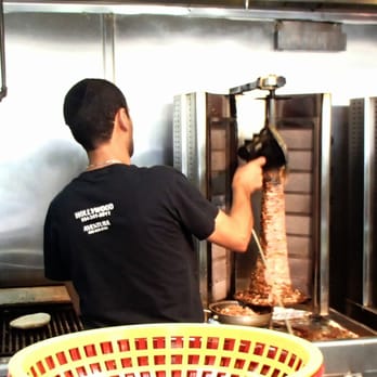 Pita Plus - Shaving the turkey and lamb mixture for the shwarma pita sandwich - Mediterranean Near Me - Dania Beach, Florida Pita Plus - Shaving the turkey and lamb mixture for the shwarma pita sandwich - Mediterranean Near Me - Dania Beach, Florida