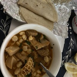 a bowl of soup and a tortilla a bowl of soup and a tortilla