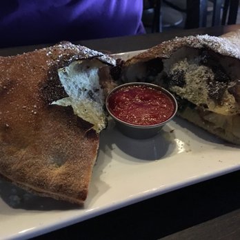 Pizza Rock - Just look at the perfect crispyness of this calzone...with amazing flavors inside! - Pizza Near Me - Henderson, Nevada Pizza Rock - Just look at the perfect crispyness of this calzone...with amazing flavors inside! - Pizza Near Me - Henderson, Nevada