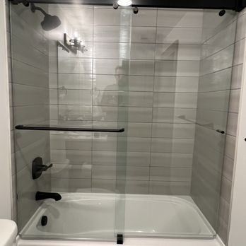 Precision Glass Service - Double bypass tub slider. Notice the notches on the bottom corners due to the tub detail. Yeah, those details matter - Glass & Mirrors Near Me Precision Glass Service - Double bypass tub slider. Notice the notches on the bottom corners due to the tub detail. Yeah, those details matter - Glass & Mirrors Near Me