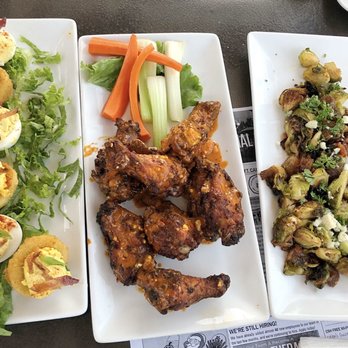 Colton's Social House - (L - R) Devil Eggs (half reg & half panko), Thai something chicken wings, & and baby Brussels sprout. - New American Near Me - Clovis, California Colton's Social House - (L - R) Devil Eggs (half reg & half panko), Thai something chicken wings, & and baby Brussels sprout. - New American Near Me - Clovis, California