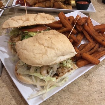 Pier House - Blackened shrimp poboy with sweet potato fries. - Bars Near Me - Orange Beach, Alabama