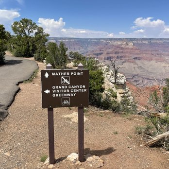 Mather Point - Walking along the paved trail approaching Mather Point. Photo is taken east of Mather Point. - Parks Near Me - Grand Canyon Village, Arizona Mather Point - Walking along the paved trail approaching Mather Point. Photo is taken east of Mather Point. - Parks Near Me - Grand Canyon Village, Arizona