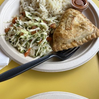Bombolé - The pork empanada, basmati rice, Honduran slaw, and tikka masala sauce - Indian Near Me - Tucson, Arizona