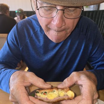 E ala Cafe - My significant other chowing down on his croissant sandwich. - Cafes Near Me - Kapaʻa, Hawaii