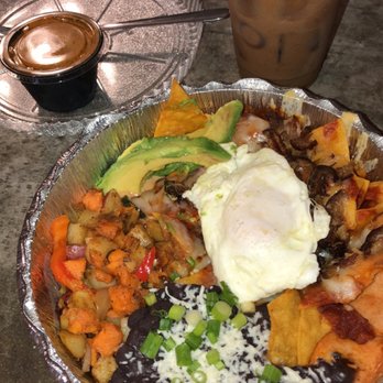 Eldorado Cafe - Chilaquiles Rojas - Homemade Totopos, Carnitas, Fried Egg, Red Chile Sauce, Queso, Jack Cheese. w/ 3 Potato Hash & Black Beans. + a Cortado! - Mexican Near Me - Austin, Texas
