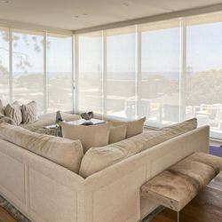 Foam & Fabrics - Amazing living room with roller shades for added UV protection
