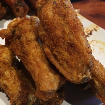 Twin Peaks - The best wings I've ever had here. It's like a fried Cajun style. Not on the menu. Our waitress eats hers like this! Fried Wings - Sports Bars Near Me - Irving, Texas