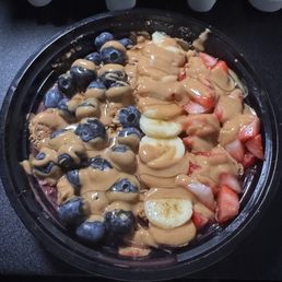 Açai bowl, bananas, strawberries, blueberries, granola, honey, and peanut butter. Açai bowl, bananas, strawberries, blueberries, granola, honey, and peanut butter.