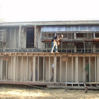 Clean And Sober Hauling - a man on the roof of a house - Junk Removal & Hauling Near Me