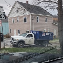 Dumpster being delivered.