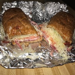 a ham and cheese sandwich on tin foil