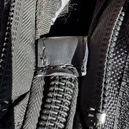 Leather added to broken zipper connector, making the cover permanently attached, and eliminating need to completely replace zipper. Leather added to broken zipper connector, making the cover permanently attached, and eliminating need to completely replace zipper.