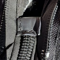 Luggage Service - Leather added to broken zipper connector, making the cover permanently attached, and eliminating need to completely replace zipper.