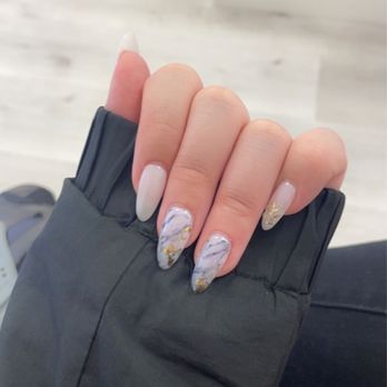 Bella Nail Lounge - Gel x short stiletto nails, with two marble designs, gold flakes and gold stickers. Base color is an off white/ milky color - Nail Technicians Near Me - Irvine, California