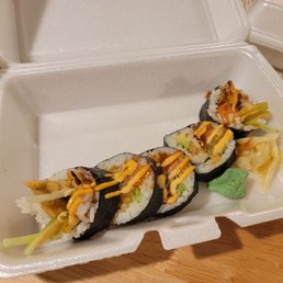 a sushi roll in a styrofoam container a sushi roll in a styrofoam container