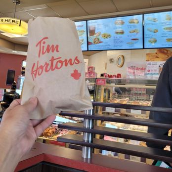 Tim Hortons - a person holding a bag of food - Bakeries Near Me - Prince Rupert, British Columbia Tim Hortons - a person holding a bag of food - Bakeries Near Me - Prince Rupert, British Columbia