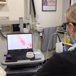 Bellingham Dental Group - A dental assistant at Bellingham Dental Group uses advanced digital imaging technology to scan a patient's teeth...