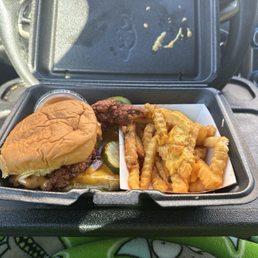 Medium slider with cheese and french fries with cheese.