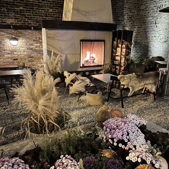 Elske - a living room with a fire place and flowers - Scandinavian Near Me - Chicago, Illinois Elske - a living room with a fire place and flowers - Scandinavian Near Me - Chicago, Illinois