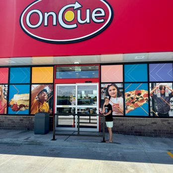 OnCue 147 - a woman standing in front of a store - Convenience Stores Near Me - Oklahoma City, Oklahoma OnCue 147 - a woman standing in front of a store - Convenience Stores Near Me - Oklahoma City, Oklahoma