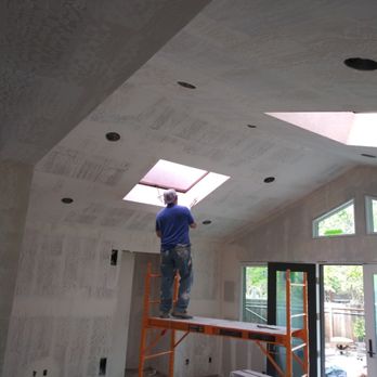 Drywall Solutions - a man standing on a ladder in a room under construction - General Contractors Near Me - Pleasant Hill, California Drywall Solutions - a man standing on a ladder in a room under construction - General Contractors Near Me - Pleasant Hill, California