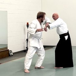 Aikido of Cincinnati - Guy is a black belt showing a white belt a hold