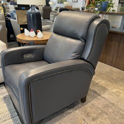 The Comfortable Chair Store - Doesn't look like your normal recliner does it? It has beautiful gun metal studs I'm not quite sure you can see. Beautiful leather.