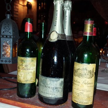 Geja's Cafe - Wine bottles offer privacy through out the restaurant. - Fondue Near Me - Chicago, Illinois