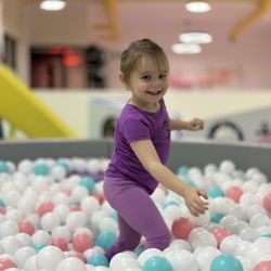 Peekaboo Play Centre - A little guest having a great time in the toddler ball pit.