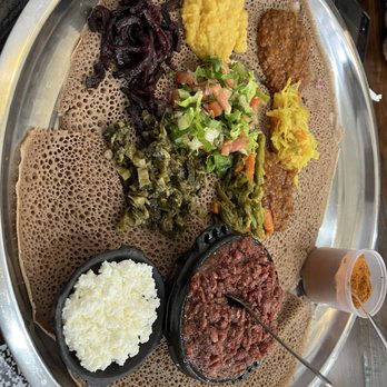 Shoa Ethiopian Restaurant - Big vegetarian platter, with the bowl of raw ground beef, the white cheese, and the cup of spice on the right. - Ethiopian Near Me - Chamblee, Georgia Shoa Ethiopian Restaurant - Big vegetarian platter, with the bowl of raw ground beef, the white cheese, and the cup of spice on the right. - Ethiopian Near Me - Chamblee, Georgia