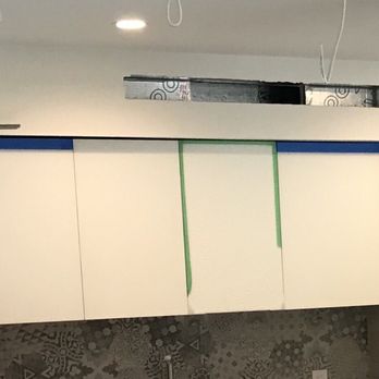 Eurocucina - Glass cabinet (green tape) smashed, cabinets installed at an angle (large gap on left) - Cabinetry Near Me - Aventura, Florida Eurocucina - Glass cabinet (green tape) smashed, cabinets installed at an angle (large gap on left) - Cabinetry Near Me - Aventura, Florida