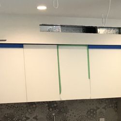 Eurocucina - Glass cabinet (green tape) smashed, cabinets installed at an angle (large gap on left)