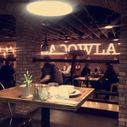 a restaurant with a brick wall