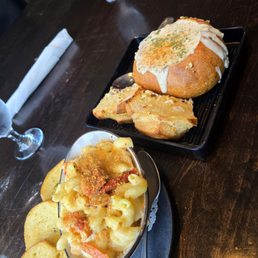 Lobster man n cheese and clam chowder in bread bowl Lobster man n cheese and clam chowder in bread bowl
