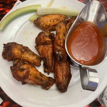 Michael Patrick's Brasserie - a plate of chicken wings with a side of sauce - American Near Me - Atlantic City, New Jersey Michael Patrick's Brasserie - a plate of chicken wings with a side of sauce - American Near Me - Atlantic City, New Jersey