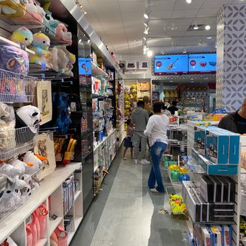 Round1 Bowling & Arcade - Eugene - Gift shop - A gift shop within an entertainment complex displays plush toys, games, and merchandise, with customers browsing the aisles. - Bowling Near Me - Eugene, Oregon