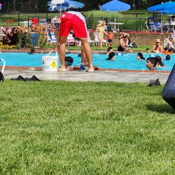 Warrenbrook Pool - Lifeguard picking up the pool lining thrown by kids and adults . Ummm ridiculous 7/22/23