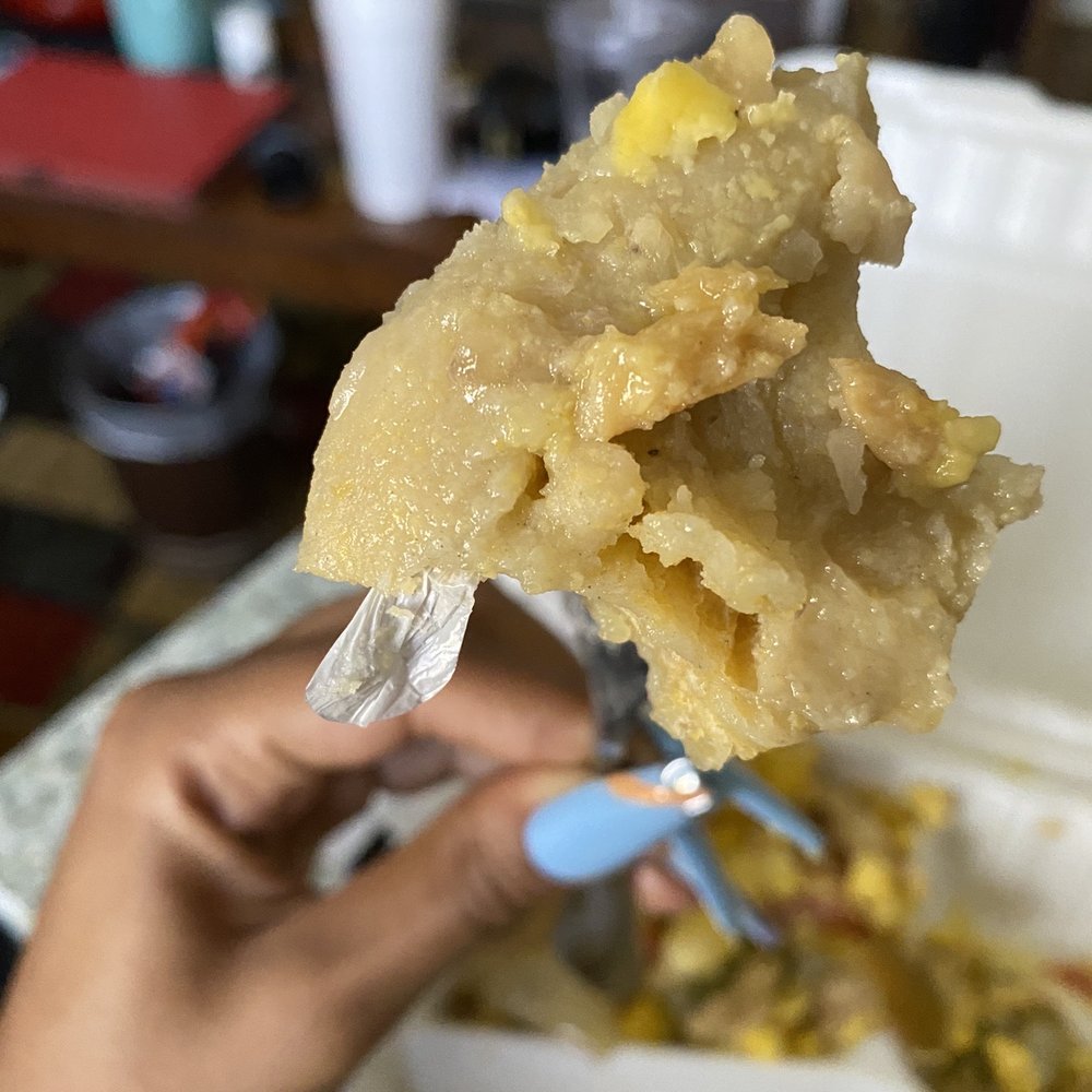 Top Taste - a person holding a fork full of food - Caribbean Near Me - Irvington, New Jersey