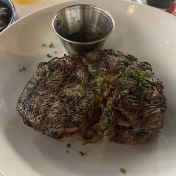 Zeke's Restaurant - 14 oz Ribeye Steak (added chimichurri sauce) - Salad Near Me - Orange Beach, Alabama Zeke's Restaurant - 14 oz Ribeye Steak (added chimichurri sauce) - Salad Near Me - Orange Beach, Alabama