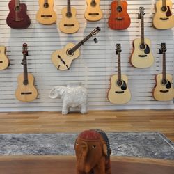 The Crossroads Guitars and Art - Our Ortega and Bodhi Guitar wall!