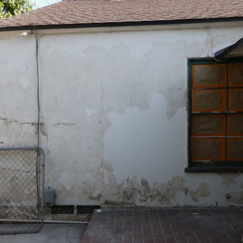 Elite Painting - Prepping the stucco and masking windows - Painters Near Me