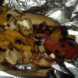 Bacon hotdog with peppers and onions.