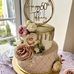Baked Bar LA - Santa Clarita - Two tier cake (top 6"). Bottom with tufted design. Decorated with artificial flowers and cake topper (provided in advance by client).