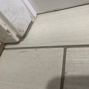 Vasko Tile - Door trim cut short to install tile and the filled with grout - Tiling Near Me