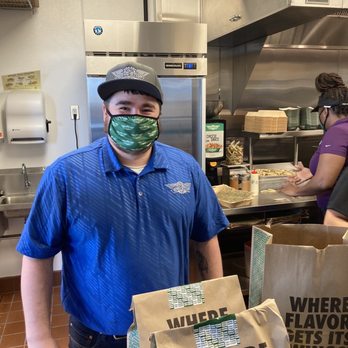 Wingstop - a man wearing a face mask in a kitchen - Chicken Wings Near Me - Lincoln, Nebraska