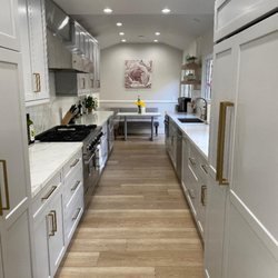 1 Day Kitchen & Bath - Light Grey Shaker Cabinets with Calacatta Laza Quartz. Full backsplash, undermount sink. Gold Pulls.
