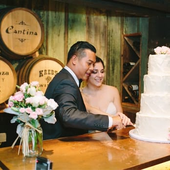 Bernardo's Flowers - A picture of my wife and I cutting our cake! To the left of us is an arrangement Bernardo's Flowers had provided for us! - Florists Near Me - Oxnard, California Bernardo's Flowers - A picture of my wife and I cutting our cake! To the left of us is an arrangement Bernardo's Flowers had provided for us! - Florists Near Me - Oxnard, California