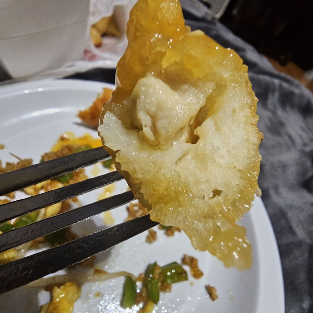 a piece of fried cauliflower on a fork a piece of fried cauliflower on a fork